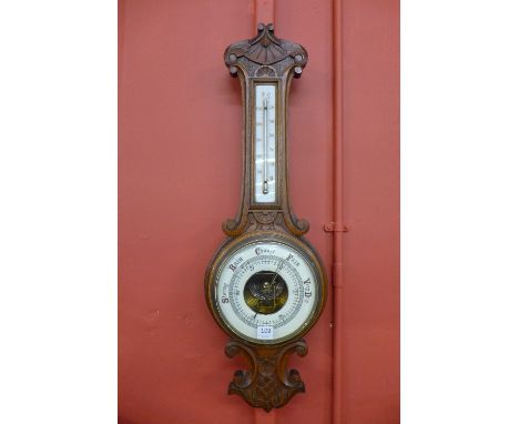 An early 20th Century carved oak aneroid banjo barometer