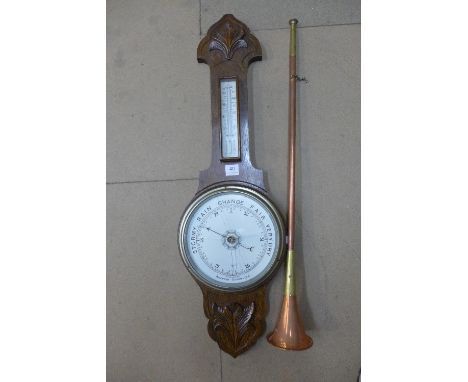 A carved oak aneroid barometer and a copper hunting horn
