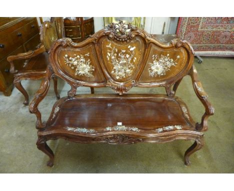 An Art Nouveau style hardwood settee inlaid with mother of pearl and abalone