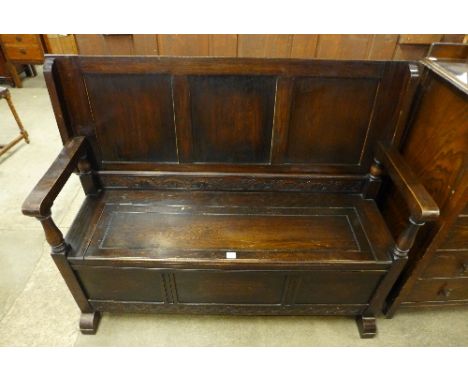 A carved oak monks bench