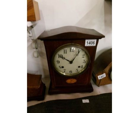 A mahogany inlaid mantel clock