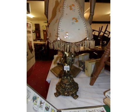 A gilded spelter cherub table lamp with shade