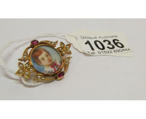 A portrait brooch set seed pearls and garnets