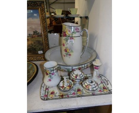 A jug and basin set with matching trinket set