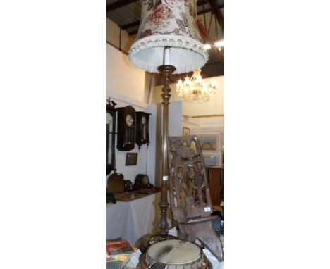 A wooden standard lamp