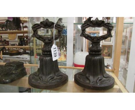 A pair of Kenrick & Sons art nouveau cast iron door stops