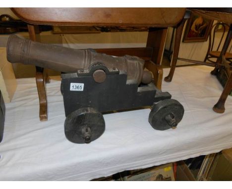 A large model cannon on wooden carriage