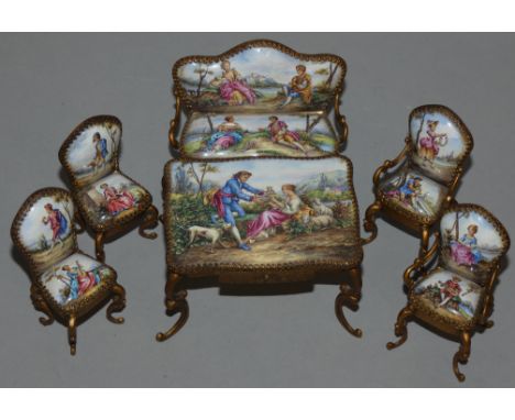 A Viennese suite of gilt metal and enamel dolls house furniture, 19th century, comprising: table, sofa and four salon chairs,