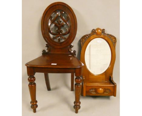 A Victorian mahogany hall chair, with carved and pierced back, together with a mahogany hall mirror with glove box, 70 cm (2)
