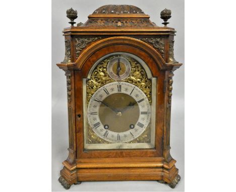 A 19th century German walnut quarter striking bracket clock, by Lenzkirch, the 5 1/2" brass arched dial with silvered chapter