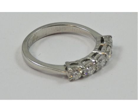 A platinum and diamond five stone ring, claw set with uniform brilliant cut stones, total weight approximately 1 cts, colour 