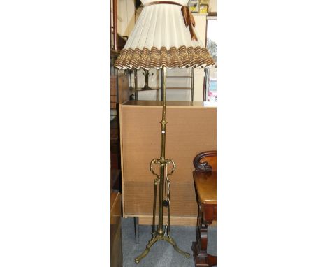 A brass standard lamp, with trefoil base, 122 cm. 
