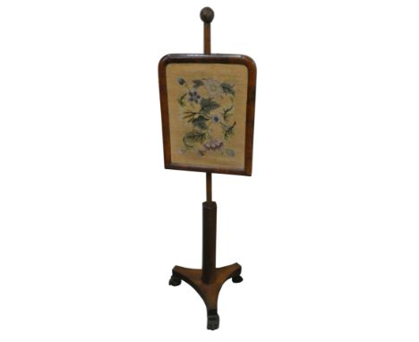 A Victorian mahogany pole screen, with a tapestry mounted sliding panel, raised on a tripod base with lion paw feet, 134 cm. 