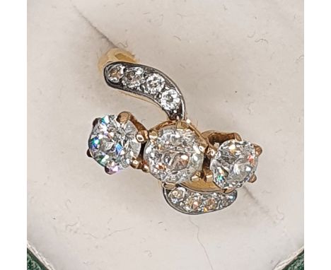 A three stone diamond ring, claw set with an old cut stone, estimated to weigh 0.75 cts, colour estimate I/J, clarity estimat