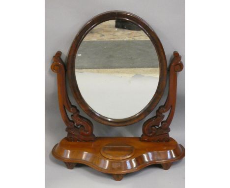 A Victorian swing dressing table mirror, the oval glass with carved supports, the base with hinged compartment, 75 x 65 cm. 