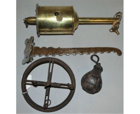 A 19th century clockwork bottle jack roasting spit, with key and cast iron balance wheel, the wheel with slotted and carrying