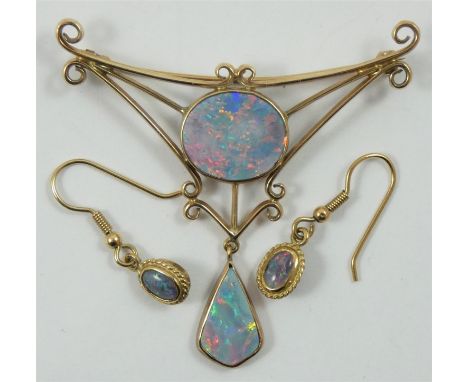 A 9ct gold and opal doublet brooch, collet set with a circular stone in an openwork mount, drop below, together with a simila