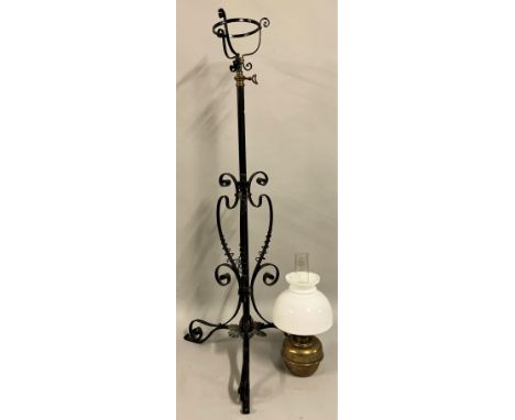 A Victorian copper and wrought iron adjustable stand oil lamp, in the style of W.A.S. Benson, raised on a tripod stand with s
