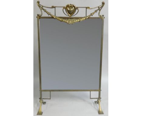 An Art Nouveau brass framed mirrored firescreen, 81cm. 