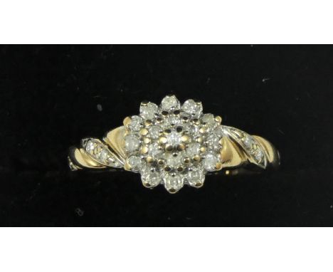 A white gold diamond cluster ring, claw set brilliant cut stones. 