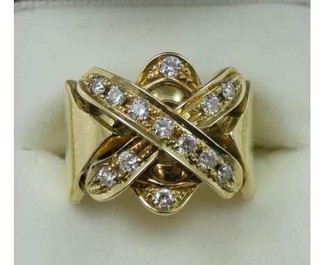 A gold and diamond dress ring, the cross motif set with 13 brilliant cut stones, weight approximately 0.50 cts, weight 13.5 g