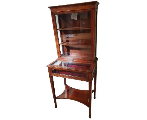 An Edwardian mahogany and boxwood inlaid display cabinet, the upper section with glazed door over a lift up bijouterie cabine