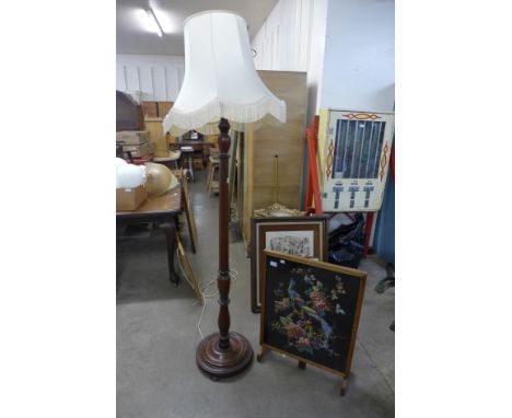 A mahogany standard lamp and an oak folding fire screen 