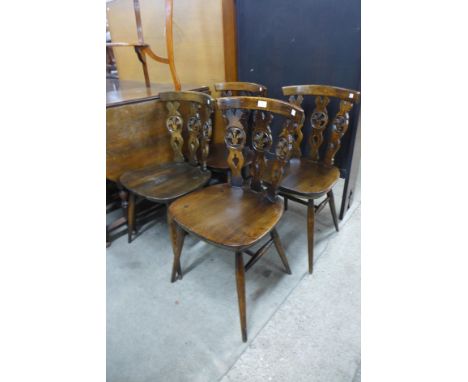A set of four Ercol dark elm and beech fleur de lys chairs 