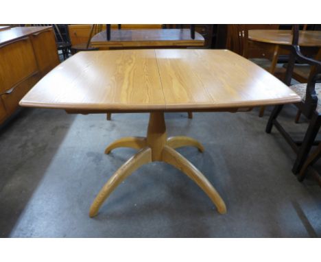 An Ercol Blonde ash Windsor extending dining table 