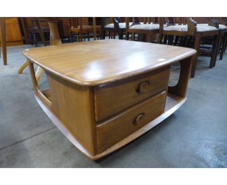 An Ercol Blonde elm Pandora's Box coffee table 