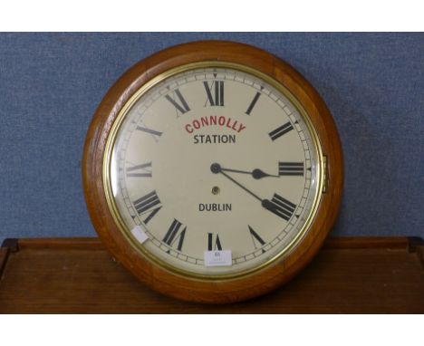 An oak circular wall clock, bearing Connolly Station, Dublin inscription to dial, 39cms d 