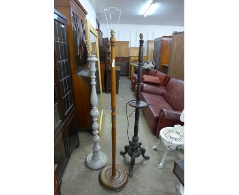 A carved oak standard lamp and two others 
