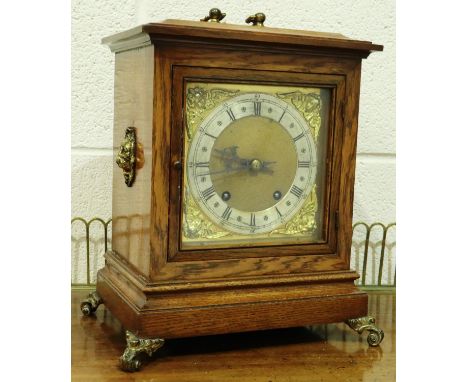 Winterhalder &amp; Hofmeier oak cased ting tang table clock with brass relief decoration, H: 33 cm, working at lotting. P&amp