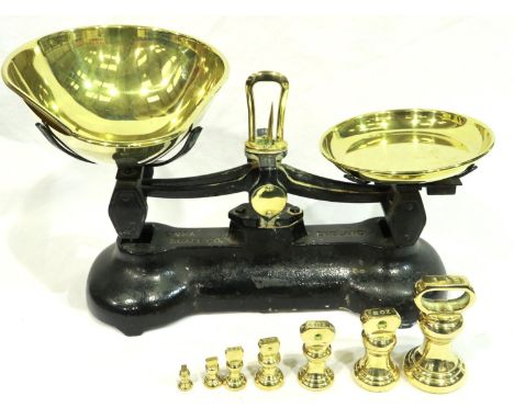 Libra black cast iron kitchen scales with brass pans and seven weights. P&amp;P Group 3 (£25+VAT for the first lot and £5+VAT