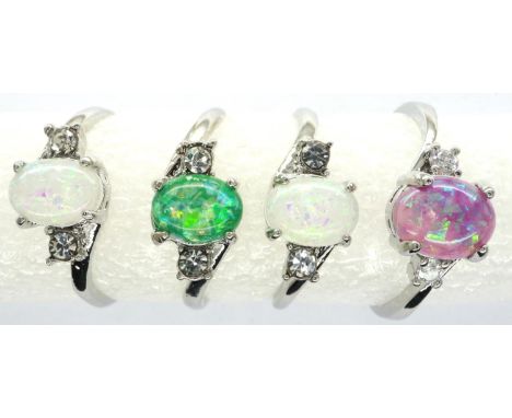 Four opalescent stone set rings, presumed silver, mixed sizes. P&amp;P Group 1 (£14+VAT for the first lot and £1+VAT for subs