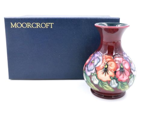 Boxed Moorcroft vase in the Pansies pattern, H: 16 cm, no cracks or chips, light crazing throughout. P&amp;P Group 1 (£14+VAT