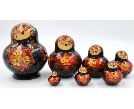 Painted wooden Russian doll set of seven pieces, each with a different facial expression, largest H: 15 cm. P&amp;P Group 2 (