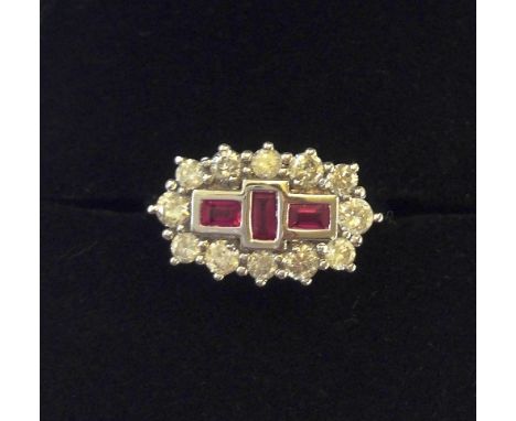 An 18 carat white gold Art Deco style ruby and diamond set cluster ring.