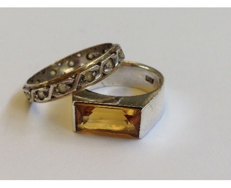 A silver citrine set gent's ring together with another silver ring.