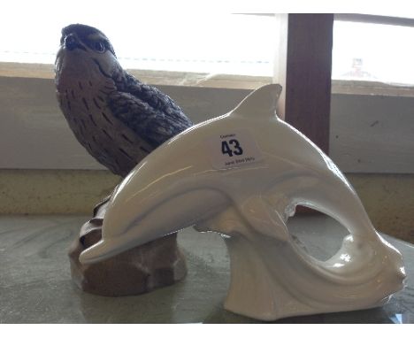 A Poole Pottery Barbara Linley Adams stoneware model of a Merlin together with a white glazed Poole dolphin.