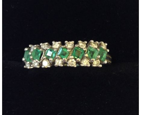 An 18 carat white gold emerald and diamond set ladies' dress ring.