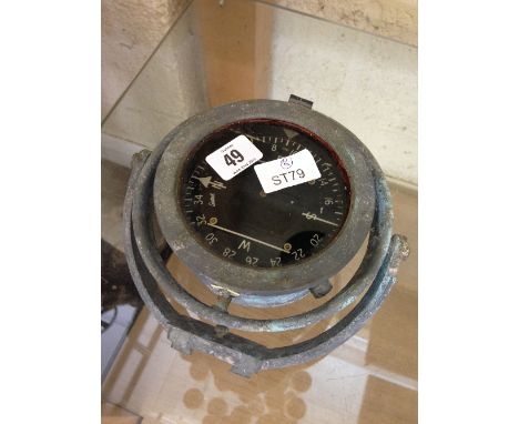 A small metal cased ship's compass.