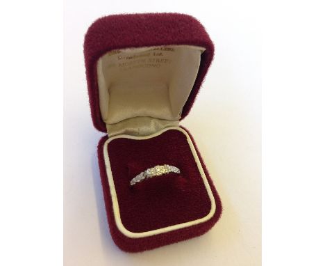 An 18 carat gold and platinum set three stone diamond ring.