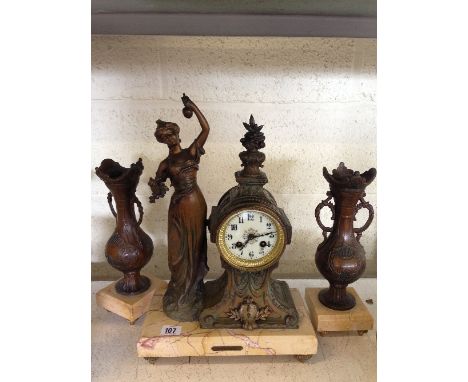 A French Spelter Art Nouveau clock garniture with enamel dial resting on a marble base.