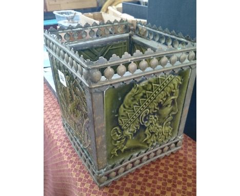 A late 19th century Mintons tile and brass framed planter, the green glazed tiles decorated with birds and portraits.
