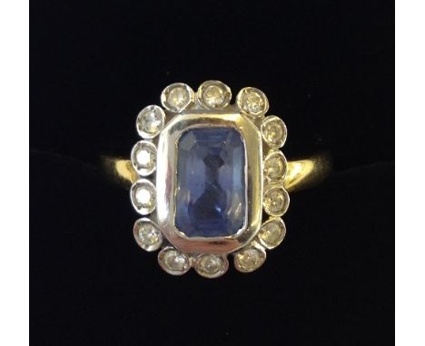 An 18 carat yellow and white gold Ceylon sapphire and diamond set ring.