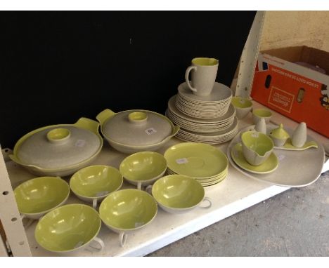 The residue of an extensive Poole Pottery Twin Tone dinner service.