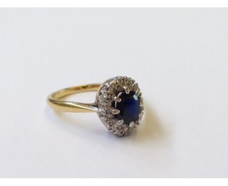 An 18 carat gold sapphire and diamond set cluster ring.