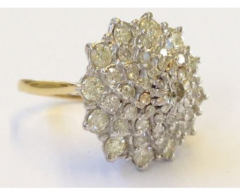 An 18 carat gold large diamond cluster ring set numerous small diamonds