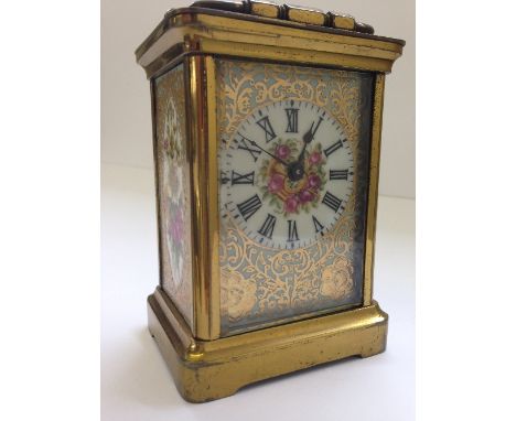 An enamel decorated glass and brass cased carriage clock.